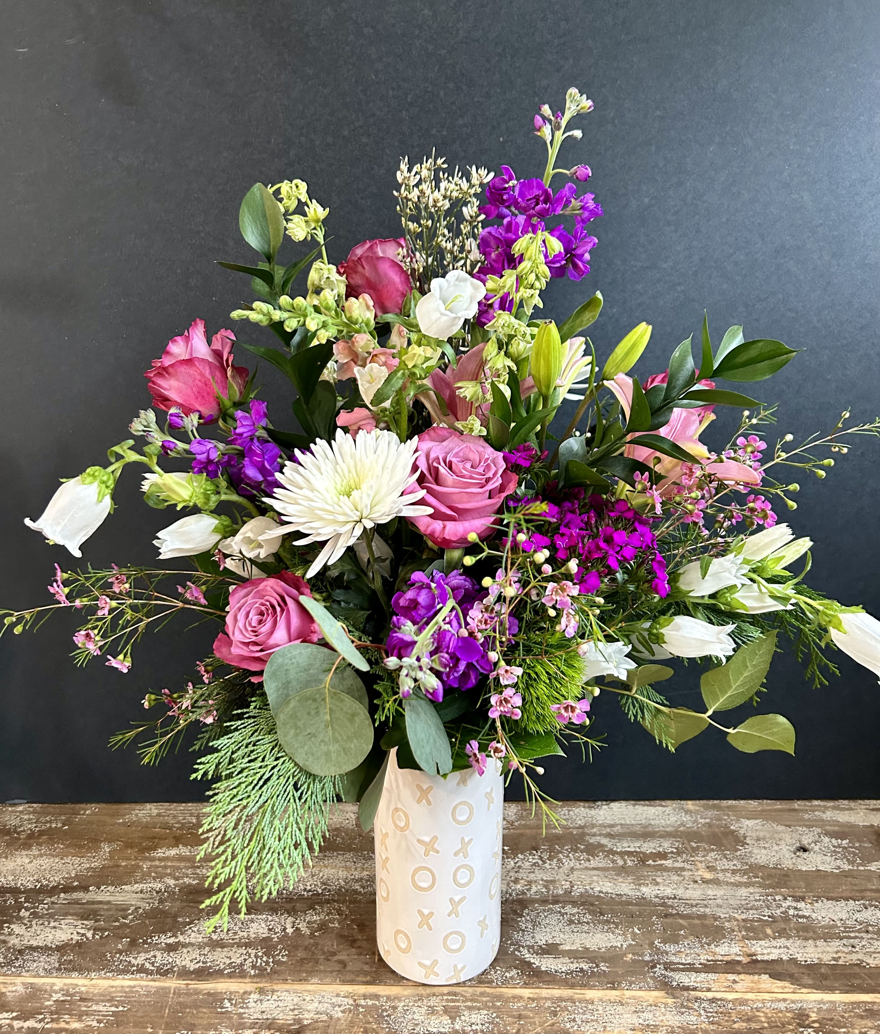 X's &amp; O's - An adorable ceramic keepsake vase is etched with so many X's and O's. The mixed arrangement will include a mix of fragrant flowers, fillers, eucalyptus and more. 