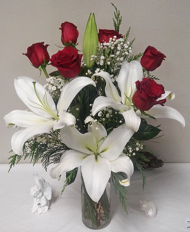 Lilies and Roses - Red roses and pure white lilies are two of the most elegant blossoms in nature; combined in one lovely floral arrangement, they create double the flower power!  A simple and elegant display that will make someone sit up and take notice.