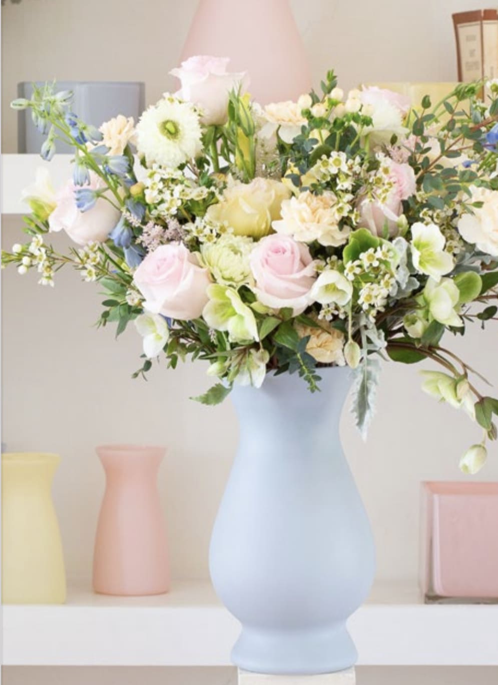 Softness of Spring - This fantastic arrangement arrives in a clear bella vase full of soft pink roses, lisianthis, waxflower &amp; delphinium **Note Pastel Vases are Out of Stock**