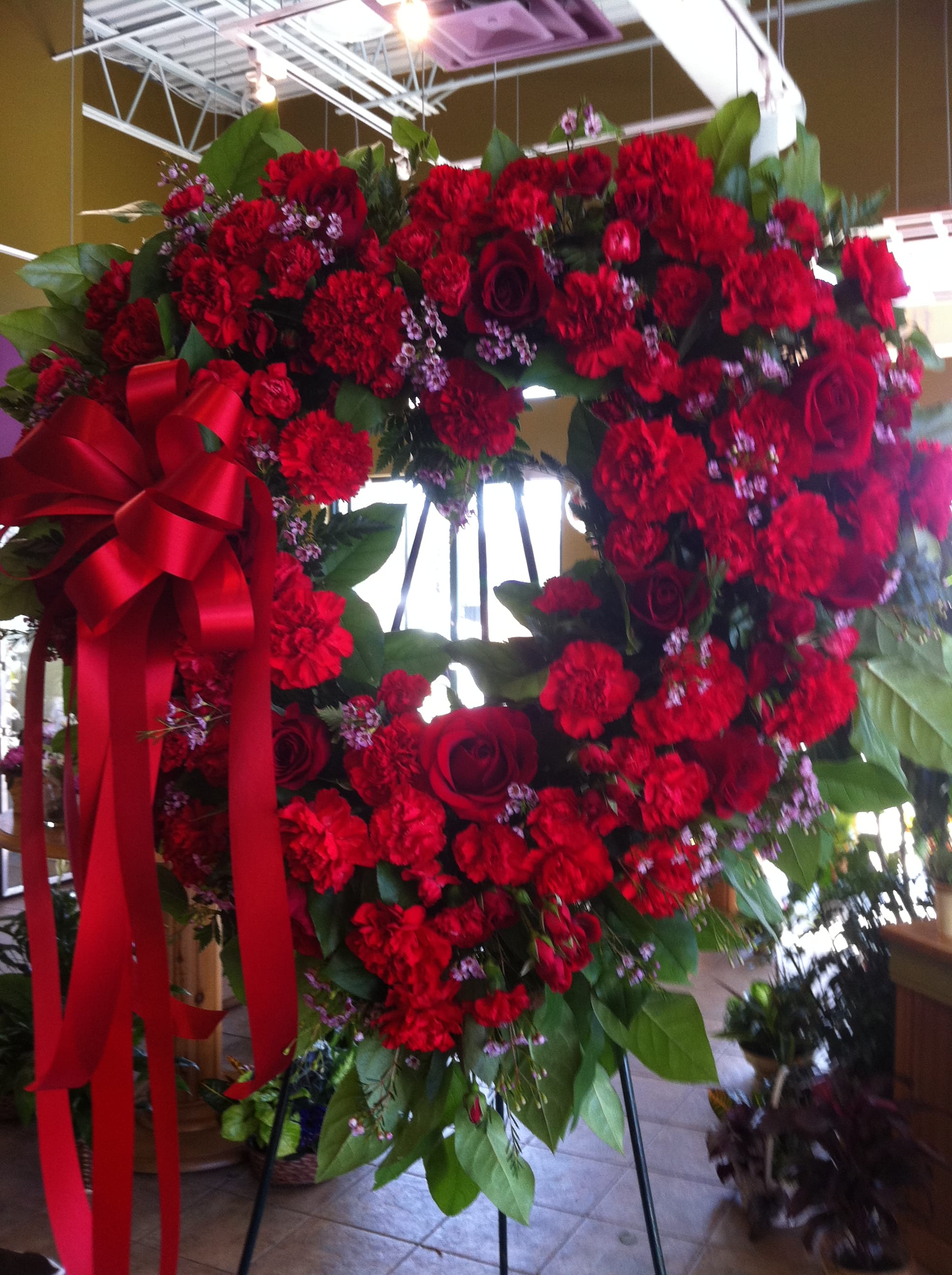 red open heart red open heart - mixed red flowers designed in open heart shape, red roses, red carnations, greenery