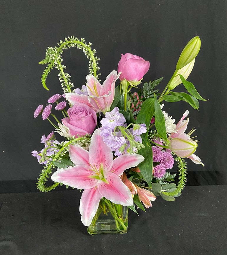 Starstruck - Grab their attention and make them starstruck with this breathtaking arrangement center around beautiful and fragrant stargazer lilies. Also includes purple roses, lavender stock, purple button poms, purple alstro, and white veronica.