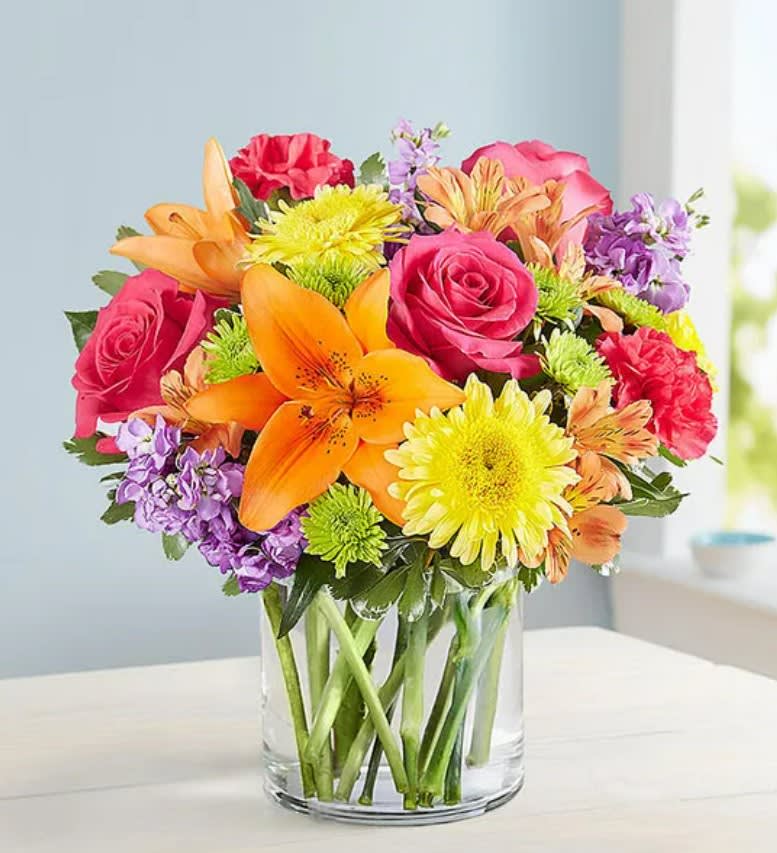 Vibrant Beauty™ - A gift to match their vibrant personality. Our must-send bouquet is designed with a bold gathering of blooms—yellow, hot pink, orange and purple—bringing lots of beauty and brightness to the big, small and in-between moments.