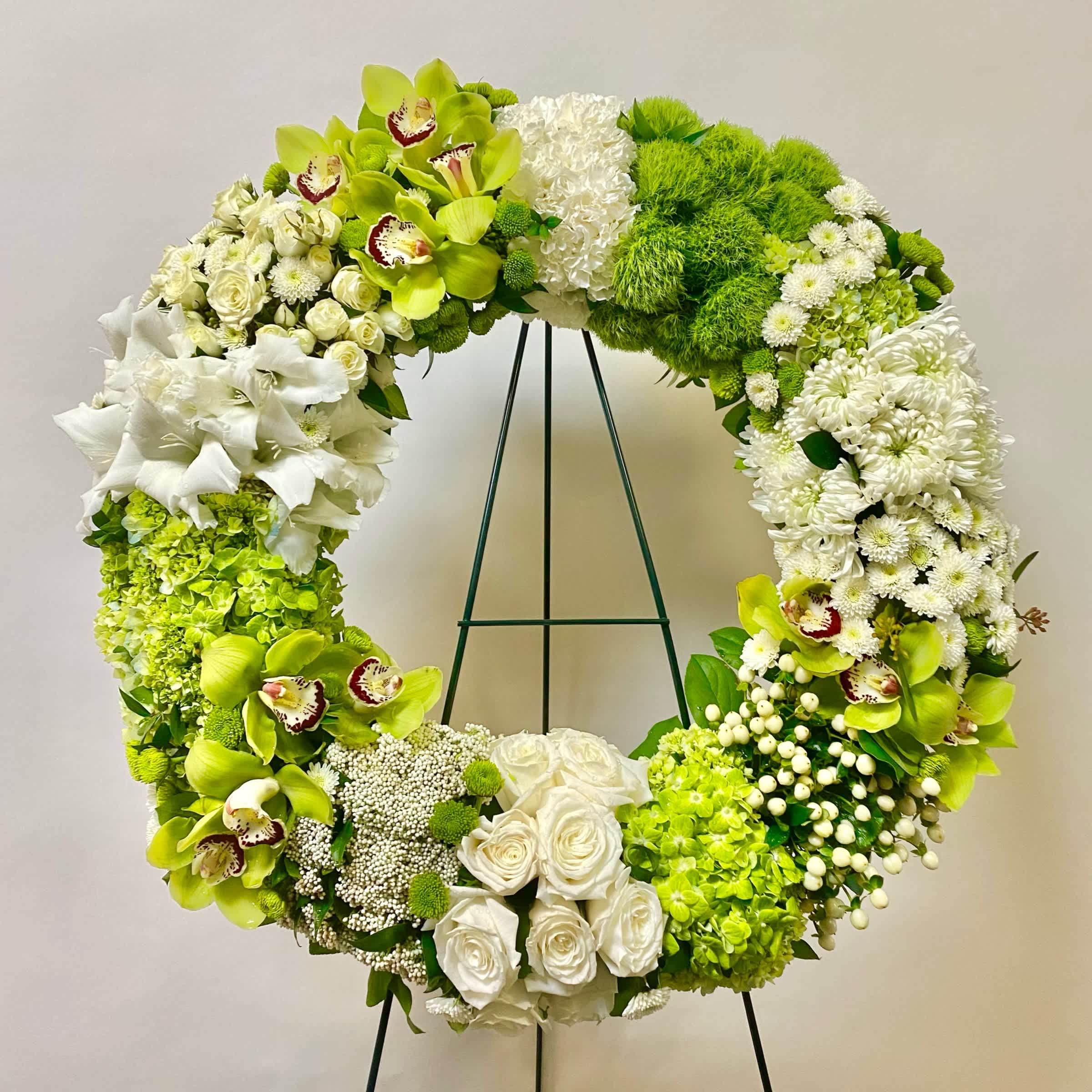 Eternal Affection Wreath - This All and Green Wreath Includes Green Cymbidium Orchids, Green Tricks, White Roses, White Spray Roses, Green Hydrangea, White Fuji Mum, White Carnations and Green Buttons. Or as Similar as Possible based on Availability.