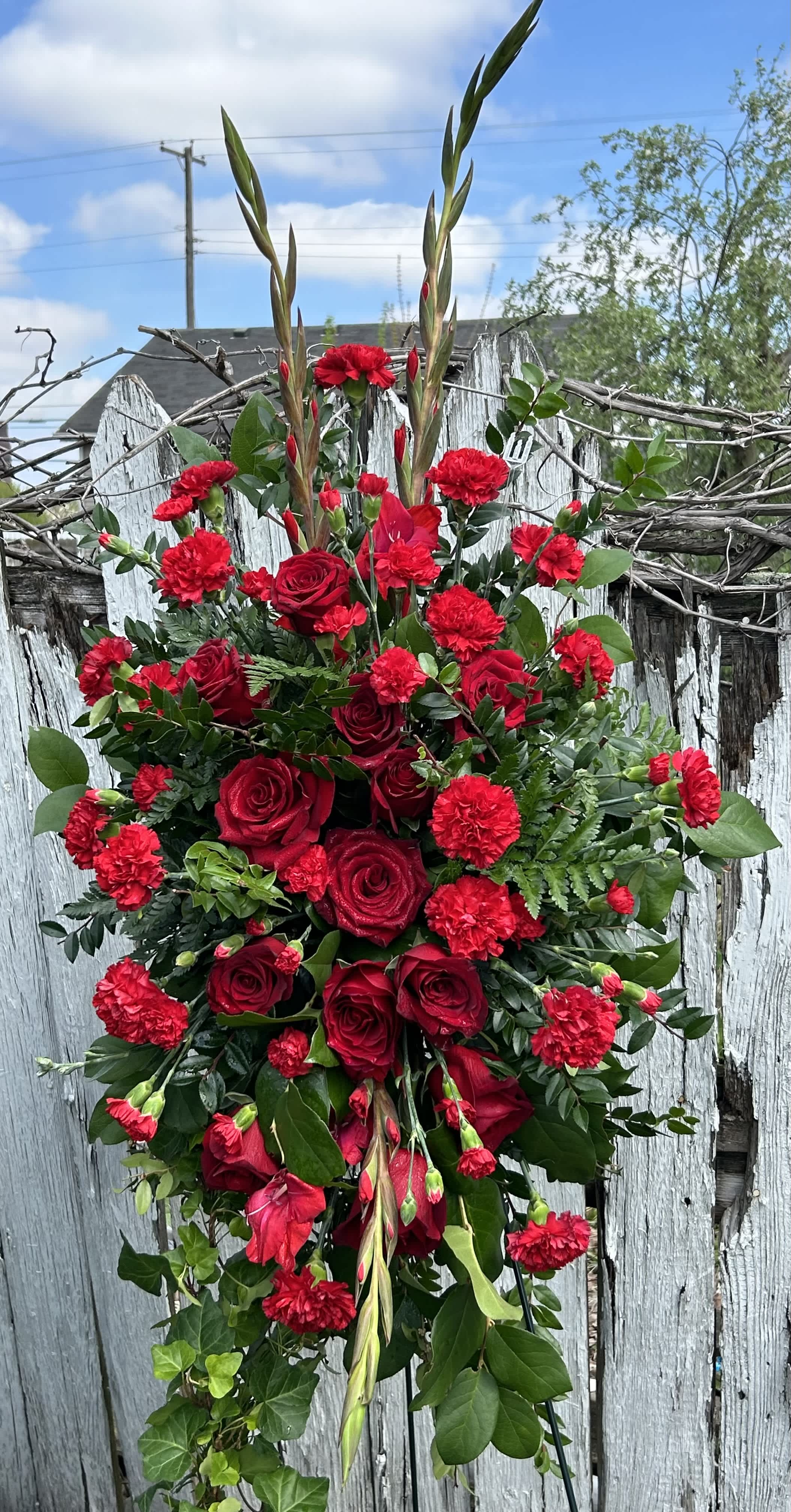 Sympathy Easel Tribute Spray Red Rose - Red roses, red gladiolus, red carnations, and lush greens