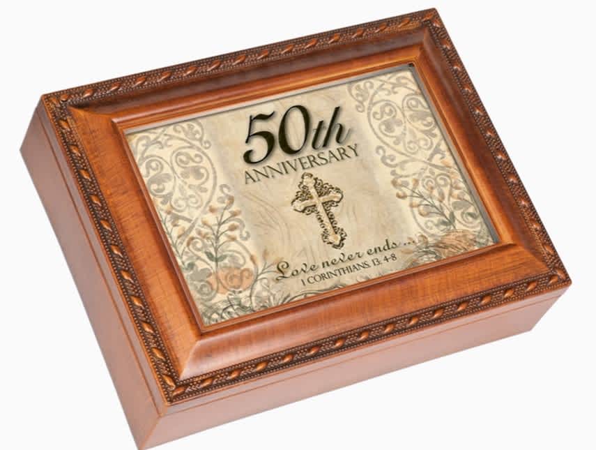 50th Anniversary - Music Box with hinged lid designed with 4 x 6 photo opening and embossed rope trim detail. Jewelry box measures approximately 6 x 4 x 2.5 inches; Replace artwork with 4 x 6 inch personal photo. Black velvet lined interior cushions your precious treasures; Decorative bun feet are padded to protect table top and shelf surfaces. Traditional wind-up mechanism engages music.  Plays: AVE MARIA