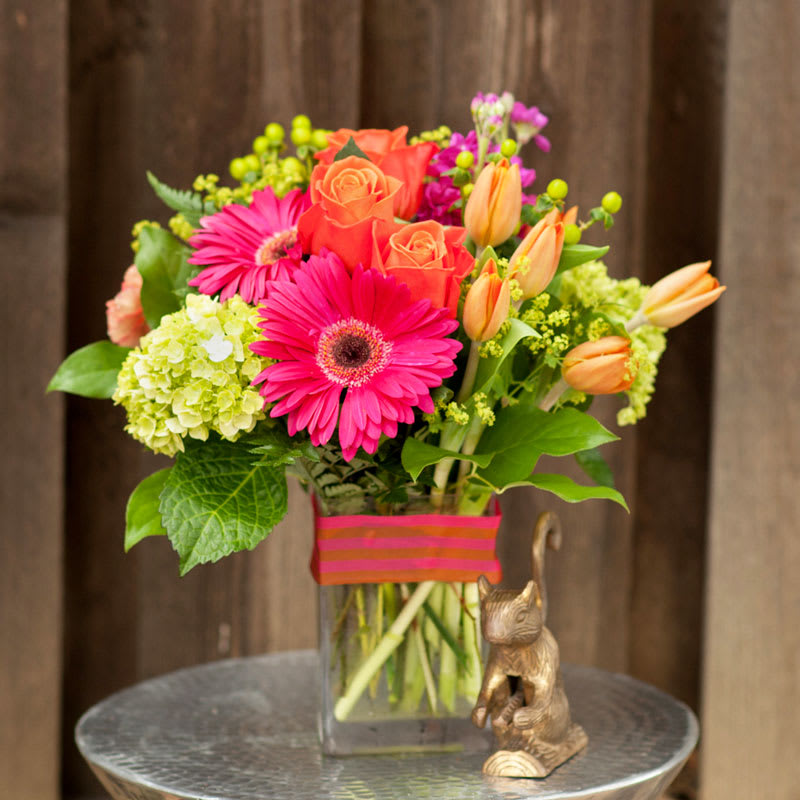 Starburst - Hot pink and orange burst out of this summery bouquet sure to brighten anyone's day! 