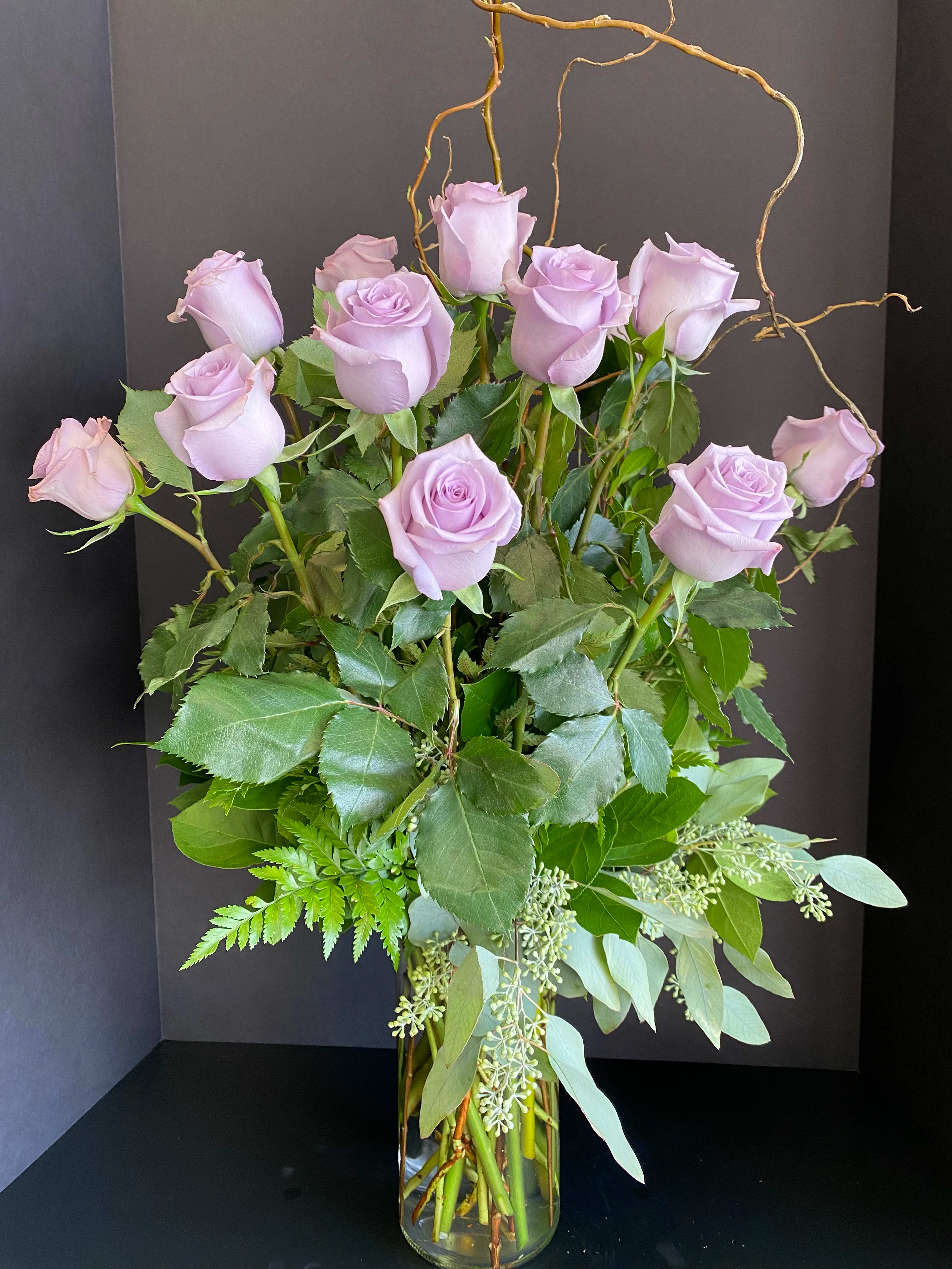 Dozen Lavender Roses - Lavender Roses with Greenery Arranged in a Glass Vase.