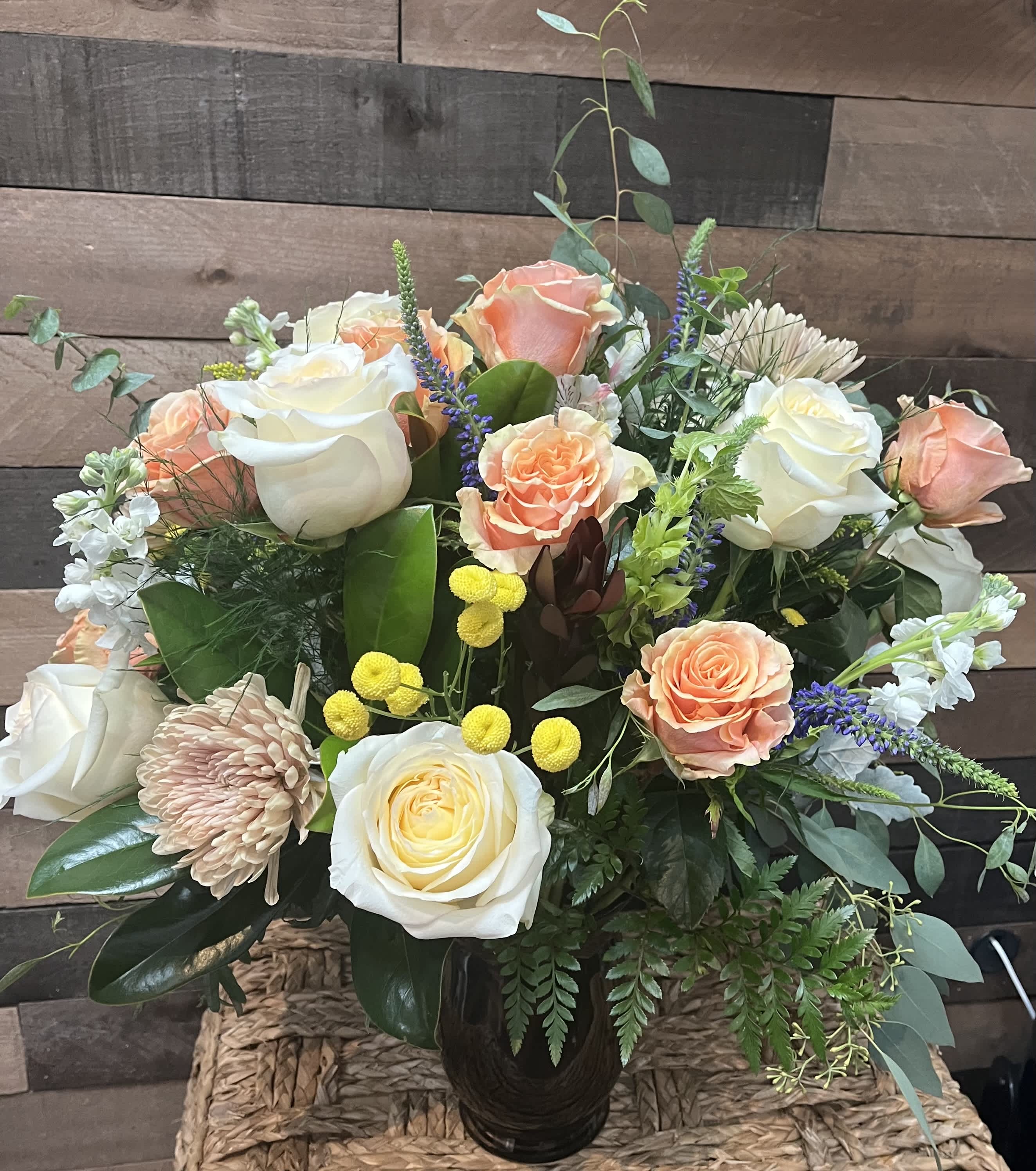 Serene Splendor - This elegant bouquet combines white and peach roses, refreshing eucalyptus, lush greenery, cheerful poms, vibrant veronicas, fragrant stock, and golden solidago. It’s a beautifully serene arrangement perfect for any refined occasion.