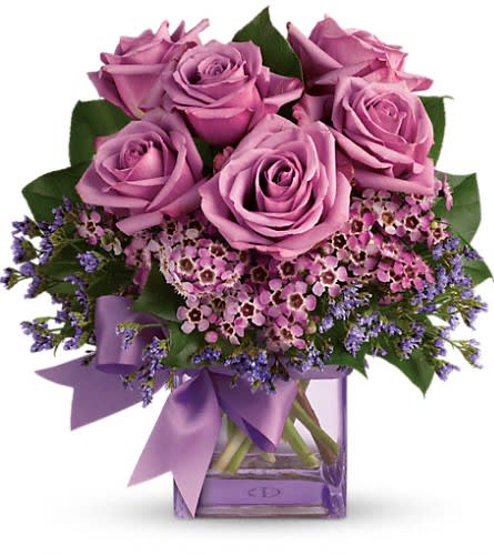 Teleflora's Morning Melody - Shades of purple are in perfect harmony in this profoundly pretty arrangement. A lovely mix of classic and modern ribbons and roses it's sure to make someone's day! Lavender roses and waxflower purple limonium and greens are hand-delivered in a lavender cube that's all wrapped up with a vibrant purple taffeta ribbon.Approximately 10 1/2&quot; W x 11&quot; H Orientation: One-Sided As Shown : T68-3ADeluxe : T68-3BPremium : T68-3C
