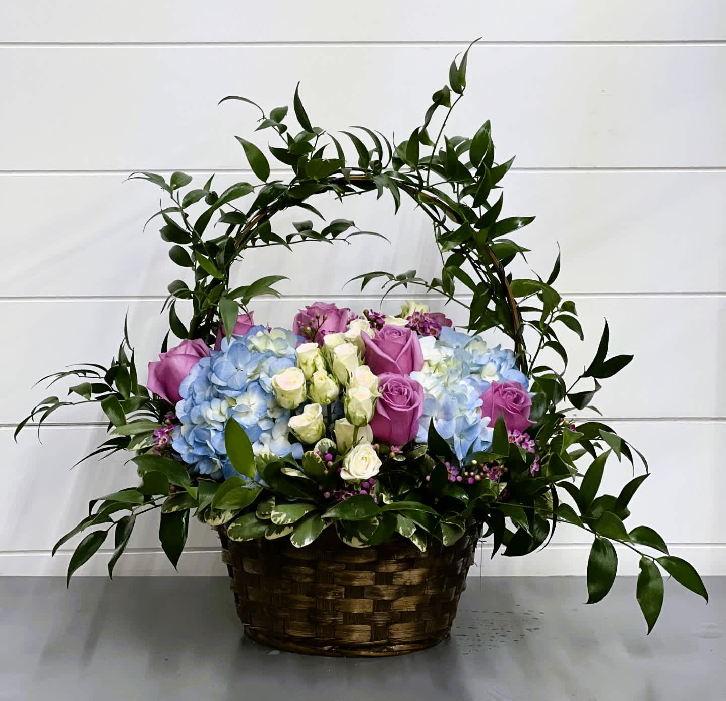 Roses & Hydrangea Basket Roses & Hydrangea Basket - Even in mourning it is important to remember and honor a life well lived. This beautiful basket of purple and white flowers blended with vibrant greenery is a wonderful way to pay tribute to one who has indeed lived a full life. T211-1A