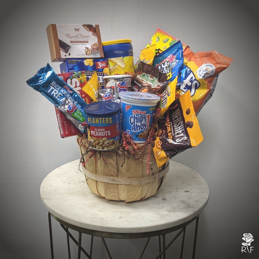 Junk Food Snack Gift Basket - Perfect for brightening any day, this Junk Food Snack Gift Basket is full of the delicious foods that everyone craves! Inside one of our signature baskets, your recipient will find a collection of delectable snacks complete with irresistibly sweet candies, pizza pretzels, and cookies. A fun and unique gift that's sure to make them smile.  *ITEMS MAY VARY