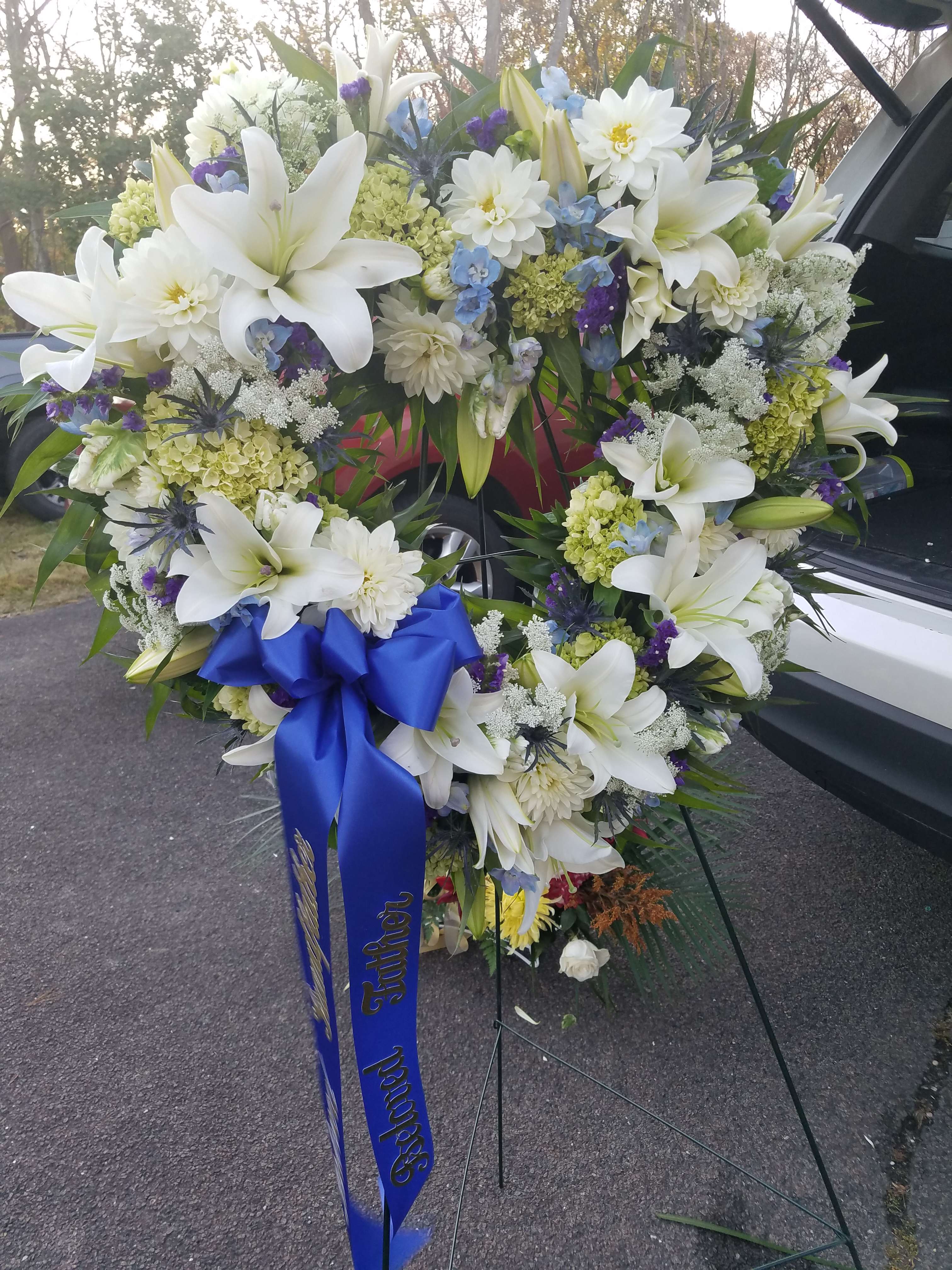 Standing Sympathy Heart Standing Sympathy Heart - Hydrangea base, large open heart, roses, lily, mums, carnations and lots of garden style blooms. Can be customized.