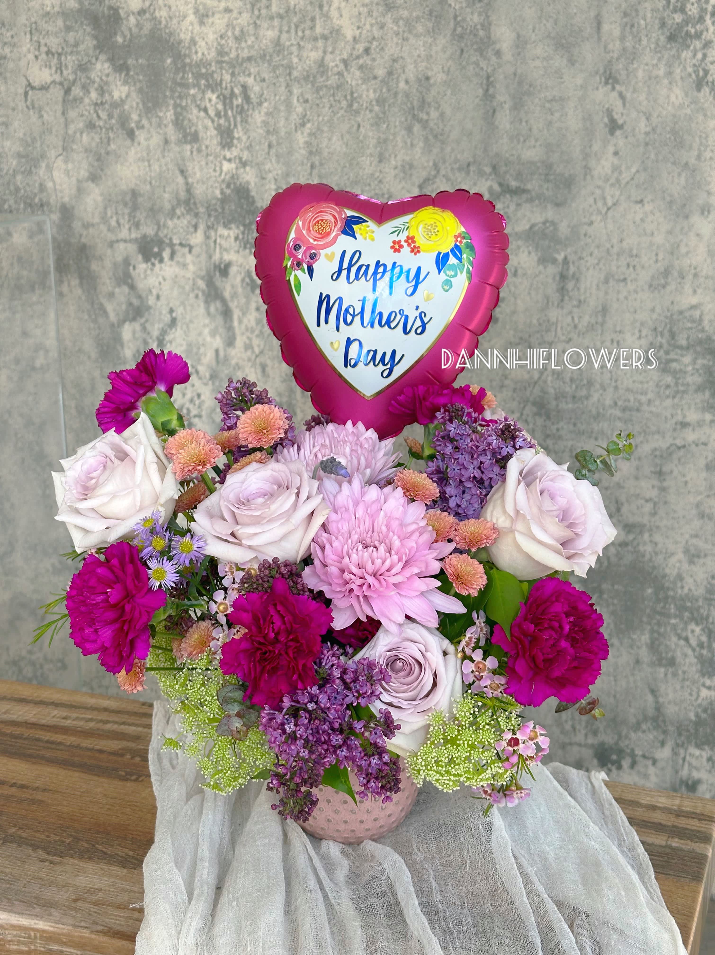 Mom’s Joy - Crafted with a delicate blend of Cremon Mum flowers, very soft lavender roses, and elegant carnations, this enchanting arrangement is designed to bring joy to every Mum on her special day.  Bouquet will be delivered appropriately as pictured.  Additional flowers will be added to enhance the arrangement for Deluxe size.  *9inches Balloon is included.