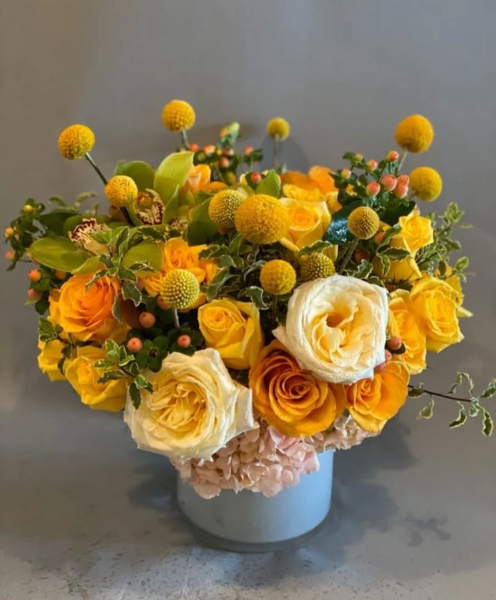 Golden Button - A sweet and sunny arrangement full of beautiful golden and amber blooms. Perfect for spreading a little sunshine to your loved ones!