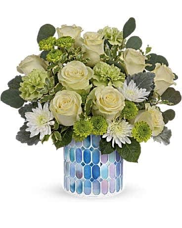 Teleflora's Serene Bliss Bouquet - Bring beauty and peace to any occasion with this serenely elegant bouquet of roses in a soothing sky-blue mosaic vase that shimmers in the light. Green roses, green carnations, green button spray chrysanthemums and white cushion spray chrysanthemums are arranged with dusty miller, silver dollar eucalyptus and pitta negra. Delivered in Teleflora's Blue Beauty Mosaic vase.