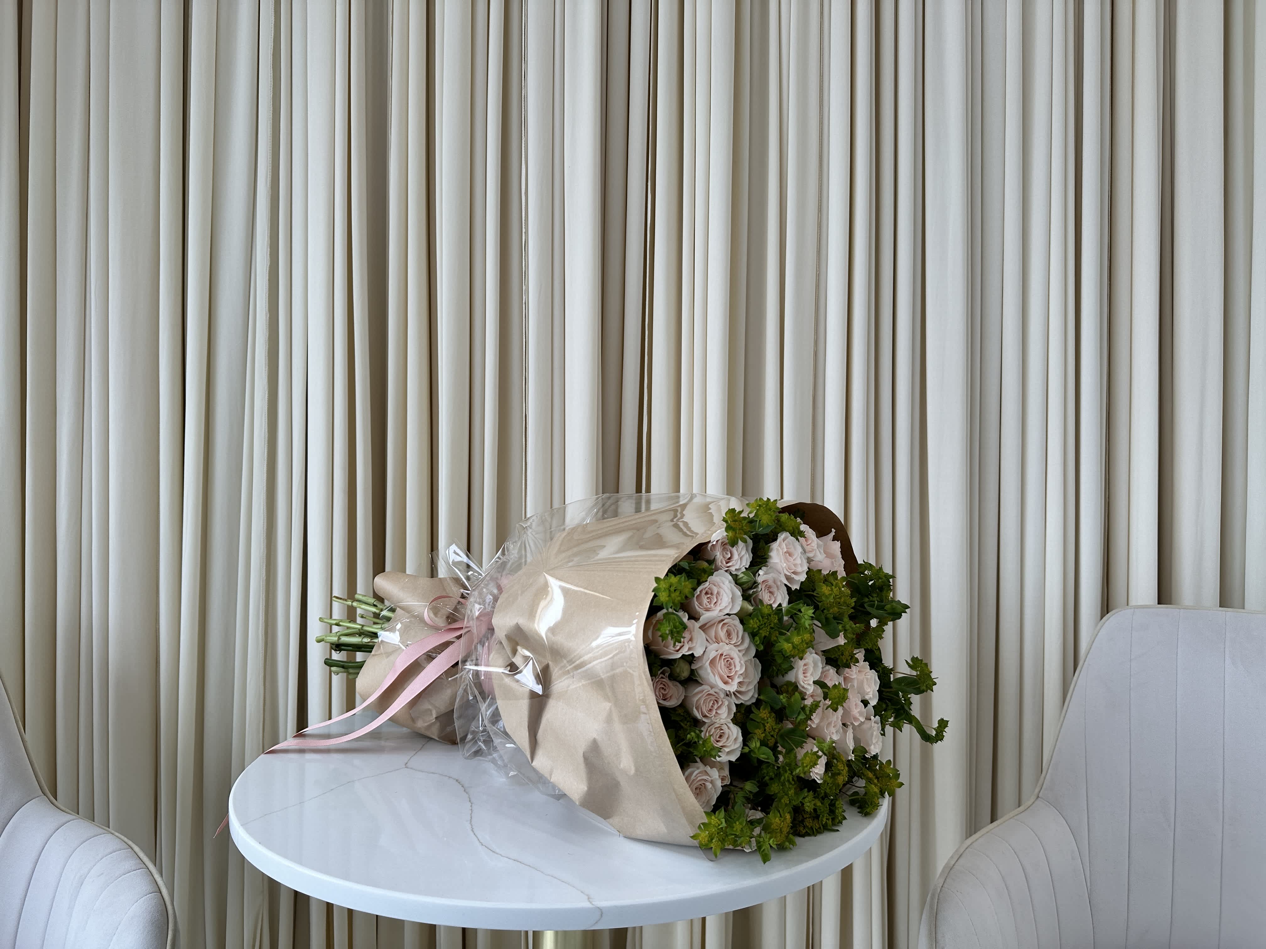 Pink-A-Boo - A basket overflowing with soft pink rosebuds, just beginning to unfurl their petals.  These delicate blooms symbolize new beginnings and potential, making them a perfect gift to celebrate a newborn baby, a new job, or any exciting new chapter in life.  Arranged in a woven basket, this sweet and sentimental bouquet is a thoughtful way to show you care.