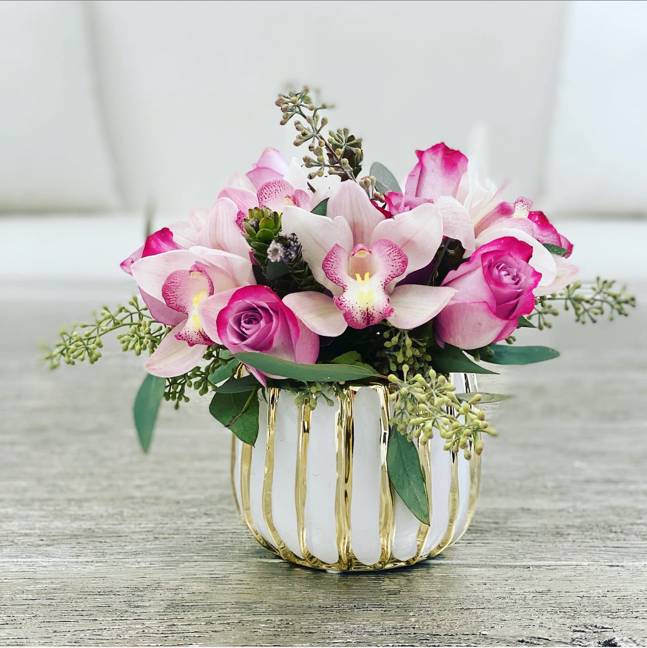 Sugar Plum Princess  - Gorgeous arrangement of Roses, Cymbidium orchids and Eucalyptus in a unique ceramic vase