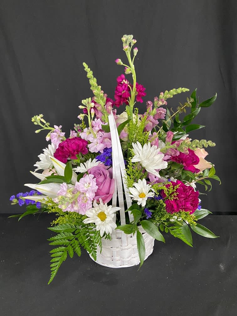 Mother's Day Special - Basket of Mom's Love - Introducing one of our 2024 Mother's Day Specials - Basket of Mom's Love. This full sized basket is packed with fresh florals including oriental lilies, roses, daisies, statice, carnations, stock, and snapdragons. Just like a mother's heart, this basket is overflowing with love!