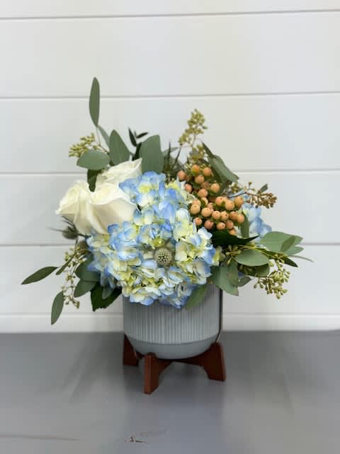 Mini Mod in blue  - Blue hydrangeas, peach hypericum, thistle an eucalyptus beautifully arranged in a gray mini mod keepsake container perfect for any occasion!    Flowers and colors may vary depending on availability.