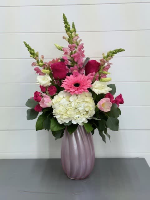 Classy Mama Bouquet - A classy assortment of hydrangeas, roses, lisianthus, gerbers, spray roses, tulips and snapdragons arranged in a pink keepsake vase.  Flowers and colors may vary depending on availability. 