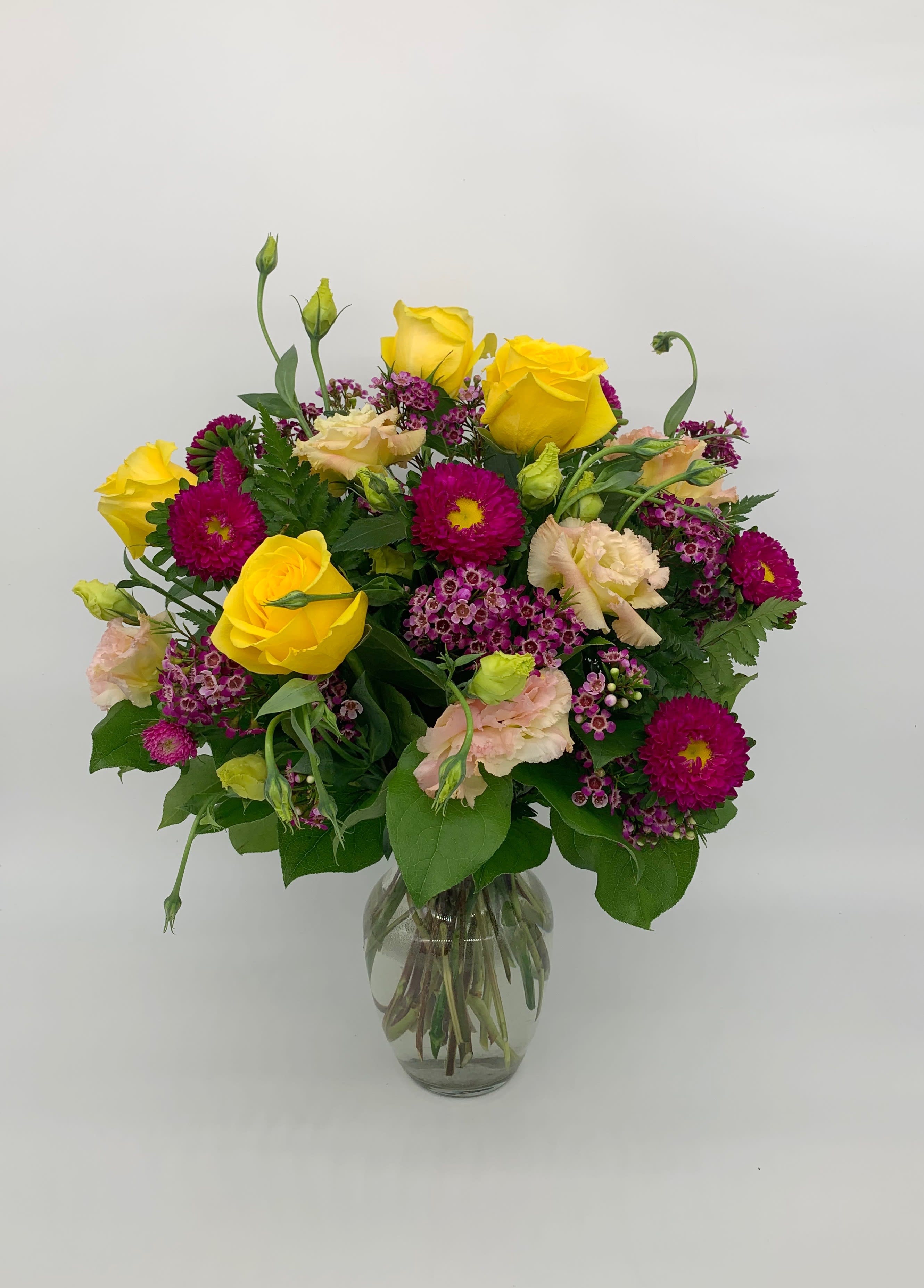 LF126 - Georgie Girl - A lovely arrangement with yellow roses accented with other seasonal flowers.