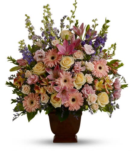 T220-1A - Loving Grace - A warm and peaceful bounty of pastel blossoms gently expresses love and respect. A gracefully composed arrangement appropriate for home or service. Fresh flowers such as peach and light pink roses lavender and purple larkspur pink asiatic lilies alstroemeria gerberas and lisianthus are set in an exclusive Noble Heritage urn.Approximately 26&quot; W x 30&quot; H Orientation: One-Sided As Shown : T220-1A