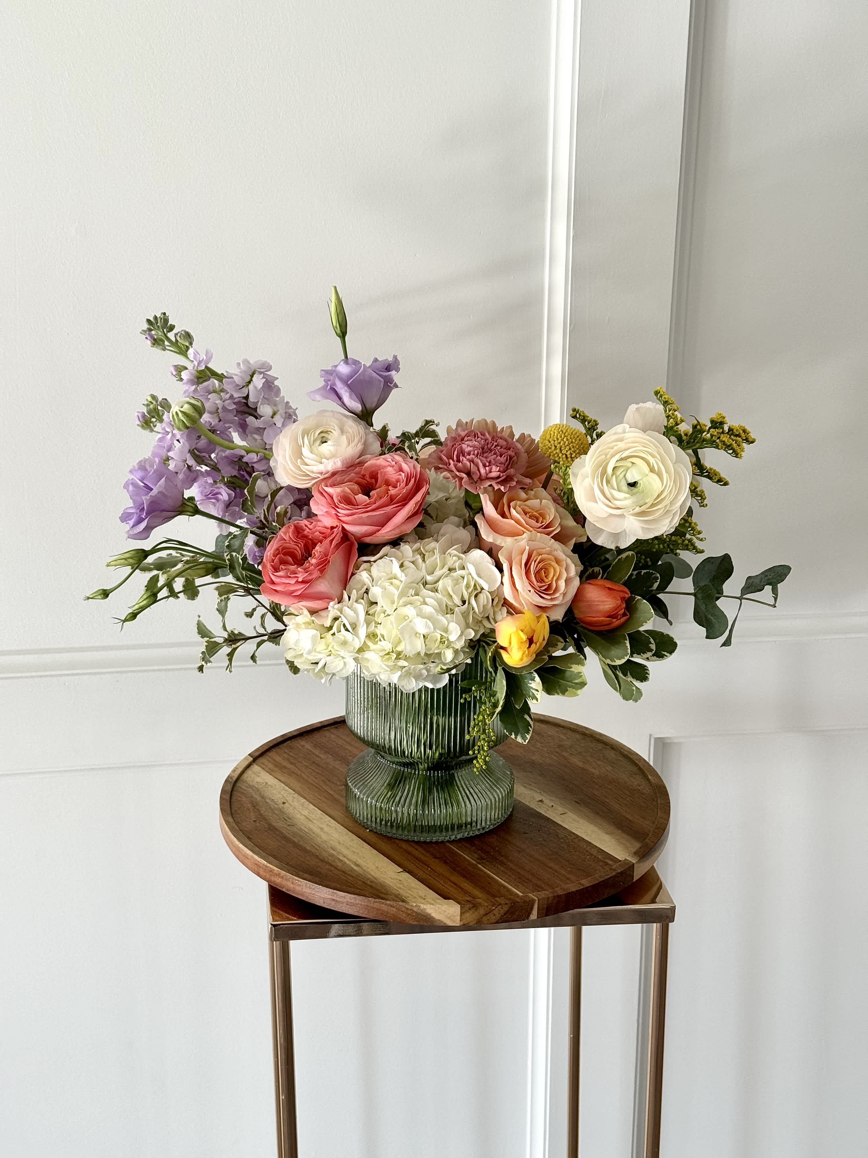 Spring Fling - A bright and colorful blend of garden roses, tulips, hydrangea and ranunculus, just to name a few. Perfect for any occasion.