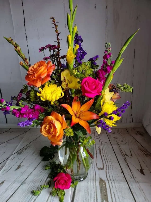 Bright Blooms - One of our most popular designs! If you're looking to send a pop of color, this is it!  Please note, these photos are meant to serve as an inspiration for color and style. Due to the seasonality of flowers, these arrangements cannot always be identically replicated.   Please contact us at 607-257-3203 with any questions.