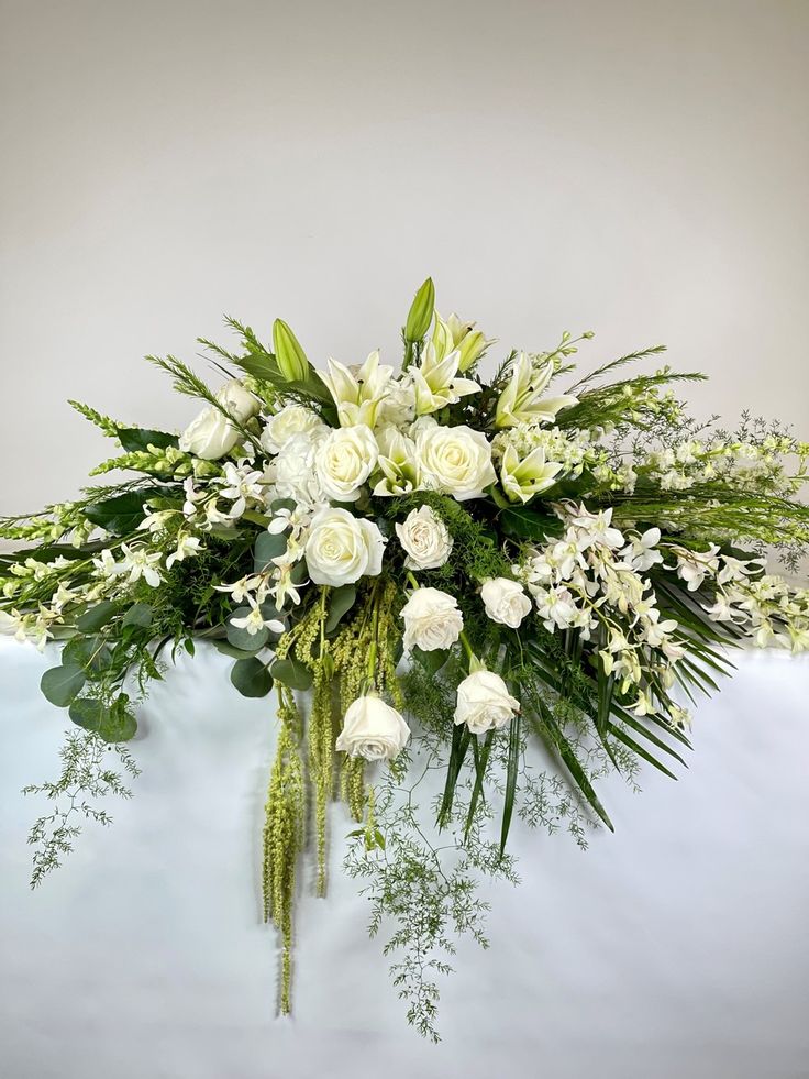Tropical Celebration of Life Casket Spray - Honor their generous spirit with a blanket of stunning tropical flowers that create a magnificent final tribute, sincerely expressing devotion and love.  (Only available in white, pink, purple, and yellow variations.)