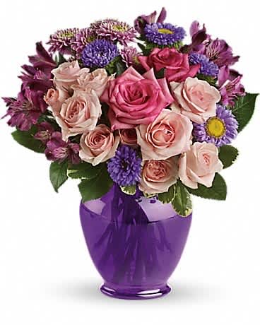 Teleflora's Purple Medley Bouquet with Roses Teleflora's Purple Medley Bouquet with Roses - Impress someone special without depressing your budget. Send lush pink and lavender flowers in a classic purple ginger jar. The exquisite bouquet includes hot pink roses, light pink roses, lavender alstroemeria, lavender matsumoto asters and lavender cushion spray chrysanthemums accented with fresh greenery.Delivered in a deep purple ginger jar vase made of durable, high-quality plastic.Approximately 11 1/2" W x 13" H