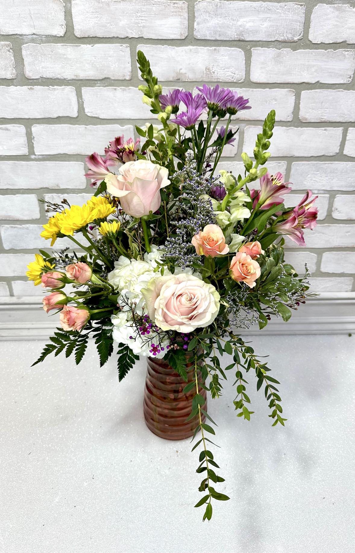 Heaven Scent - Spring flowers designed in a keepsake container, this arrangement sophisticated and timeless. *Colors may change due to availability*  