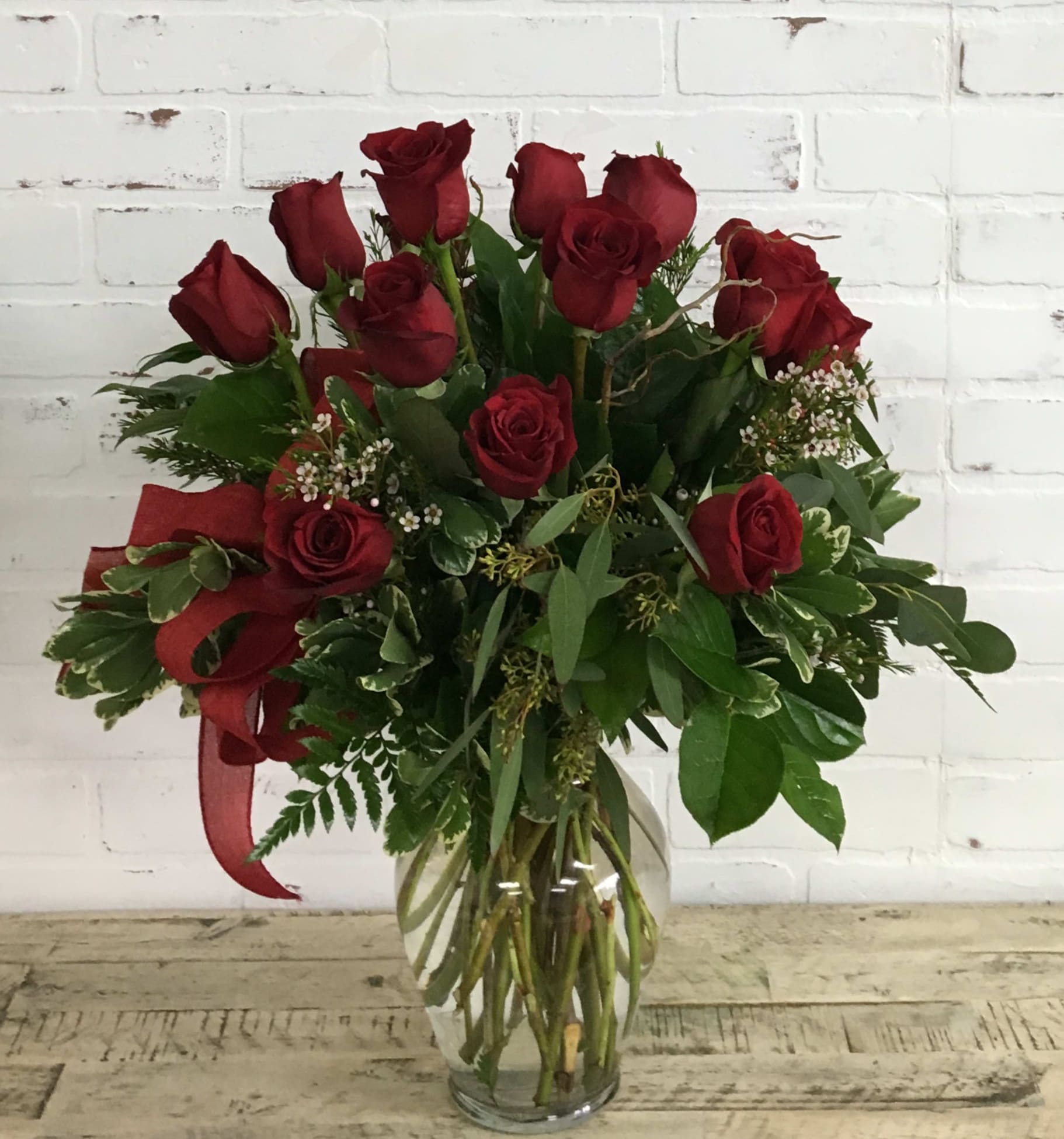 Dozen Roses - 12 roses arranged in glass vase comes in red, yellow, pink, or white. Please specify color when ordering. (Some colors may not be available at time of purchase)