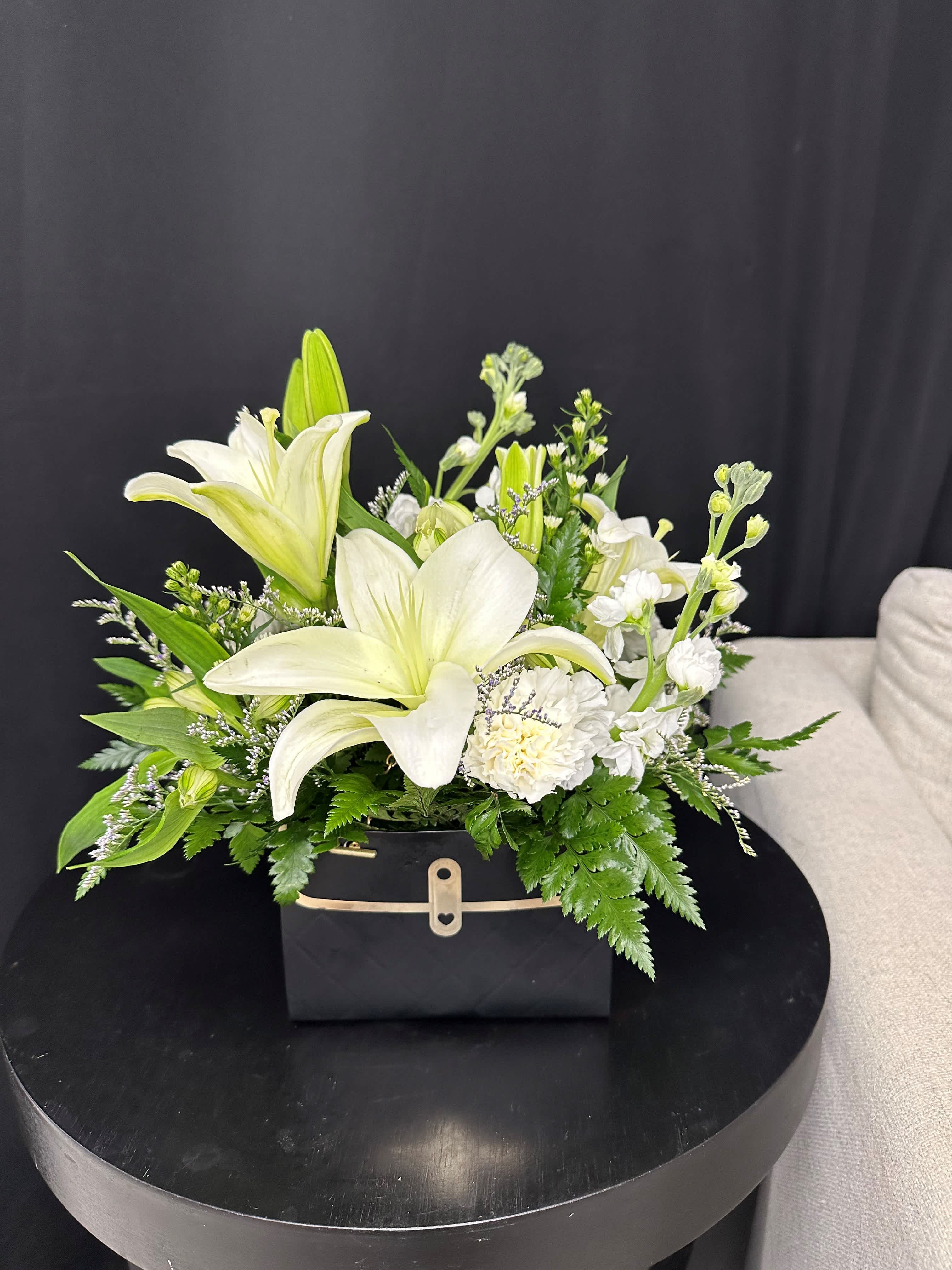 Fashion Fabulous - Unleash your fabulous side with a dainty purse brimming with yellow roses and white chrysanthemums. This charming arrangement exudes elegance and grace, making a stylish statement wherever it is displayed. Let your inner beauty shine with this delightful floral accessory.