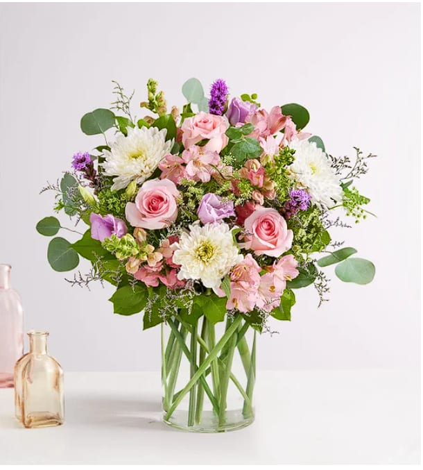 Elegant Meadow Elegant Meadow - All-around arrangement with pink roses, snapdragons and Peruvian lilies (alstroemeria), lavender lisianthus and liatris, purple Limonium, white cremons, Queen Anne’s Lace; accented with assorted greenery. Our florists hand-design each arrangement, so colors, varieties and containers may vary due to local availability