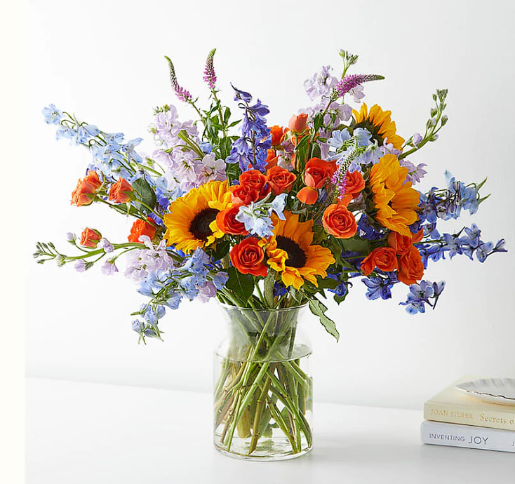 Full Nest Bouquet Full Nest Bouquet - Fell the love from these Sunflower, Spray Rose, Delphinium, Stock, Veronica elegantly arranged in a vase. Please Note: The bouquet pictured reflects our original design for this product. While we always try to follow the color palette, we may replace stems to deliver the freshest bouquet possible, and we may sometimes need to use a different vase.