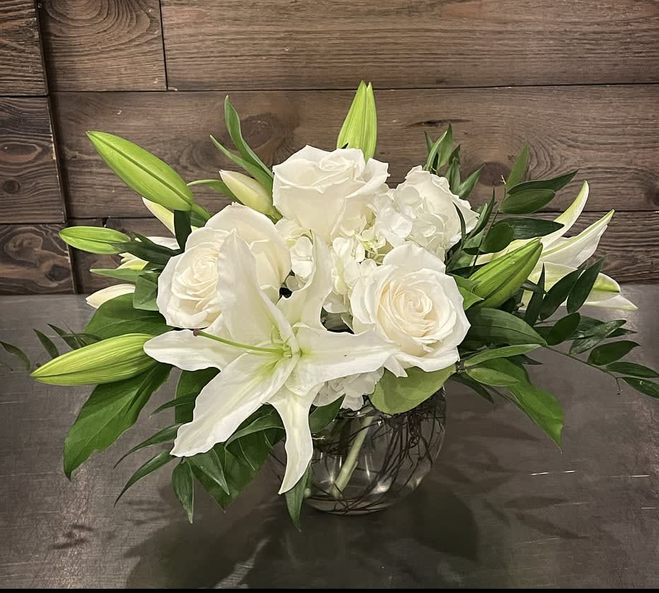 Isle of White  - In a bubble bowl vase, a mixture of all white flowers, including white lilies, hydrangea, and roses.  Approx. 8&quot; Tall x 10&quot; Wide 