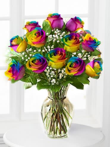 Rainbow Roses - M20R - 1 doz. Rainbow Roses arranged in a glass vase with greens &amp; babies breath.