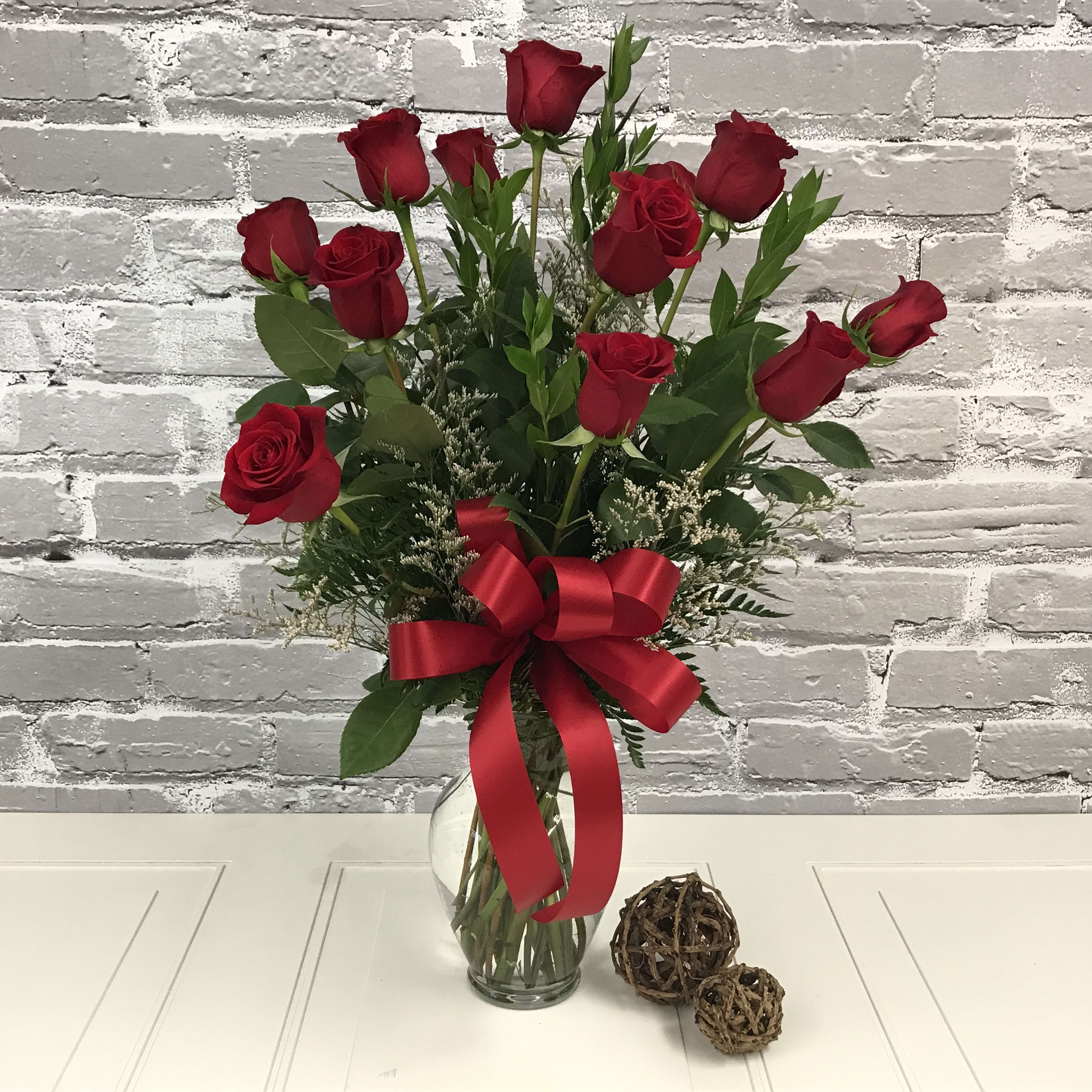 Classic Dozen Red Roses - A classic arrangement of a Dozen &quot;Freedom&quot; Roses. Complimented with lush greens and accent flowers, you can't go wrong with this classic! 