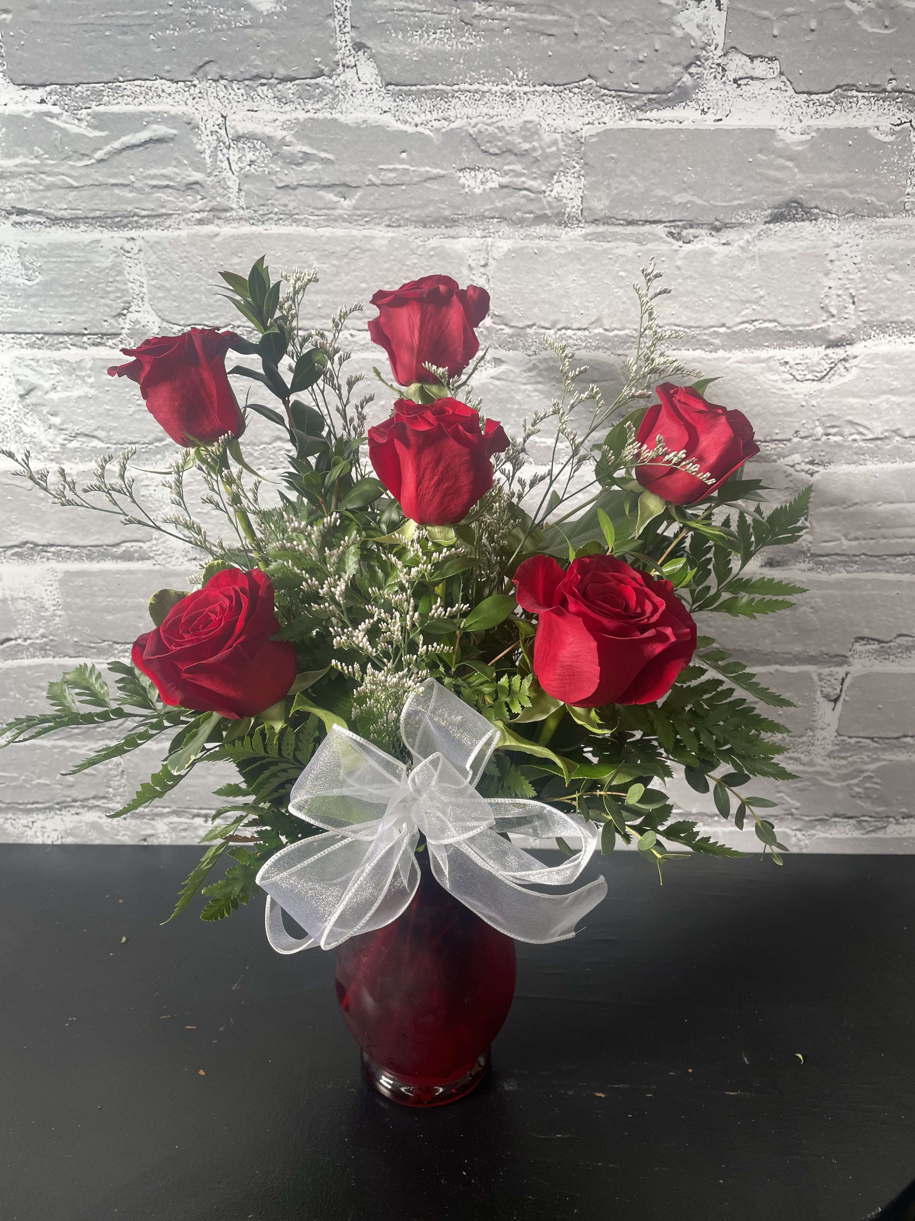 6 Red Roses - Half a dozen gorgeous red roses. Beautifully arranged in a glass vase with accent flowers, greens, and ribbon! She will love.