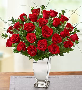 Premium Long Stem Red Roses in Silver Vase Premium Long Stem Red Roses in Silver Vase - Product ID: 105144 EXCLUSIVE There's no more romantic gesture than sending long-stem red rosesâespecially when they're from your Rose Authority! This stunning arrangement of premium blooms is gathered by our select florists inside a shimmering silver vase to help you express yourself perfectly for special birthdays, anniversaries or any day you want to say "I love you." Arrangement of premium long-stem red roses, gathered with assorted fresh greens and accented with bear grass Artistically designed by our expert florists inside a keepsake silver vase; measures 10"H Large arrangement of two dozen roses measures approximately 25"H x 18"L Small arrangement of one dozen roses measures approximately 22"H x 15"L Our florists select the freshest flowers available, so floral colors and varieties may vary