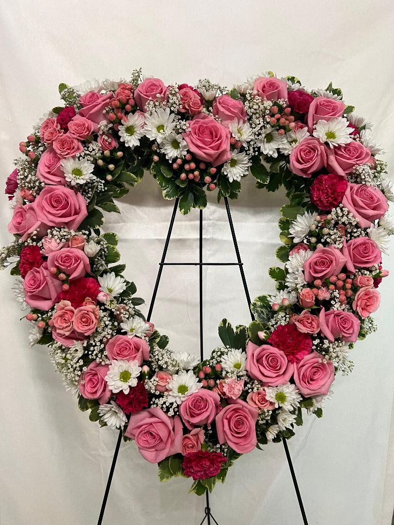 Rose Garden Heart by Teleflora - A tender and classic tribute to a precious life. Heartfelt emotions and sympathies find delicate expression here. 
