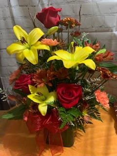 Sunshine and Happiness Sunshine and Happiness - A beautiful arrangement of red roses with yellow Lillies in a cube vase.