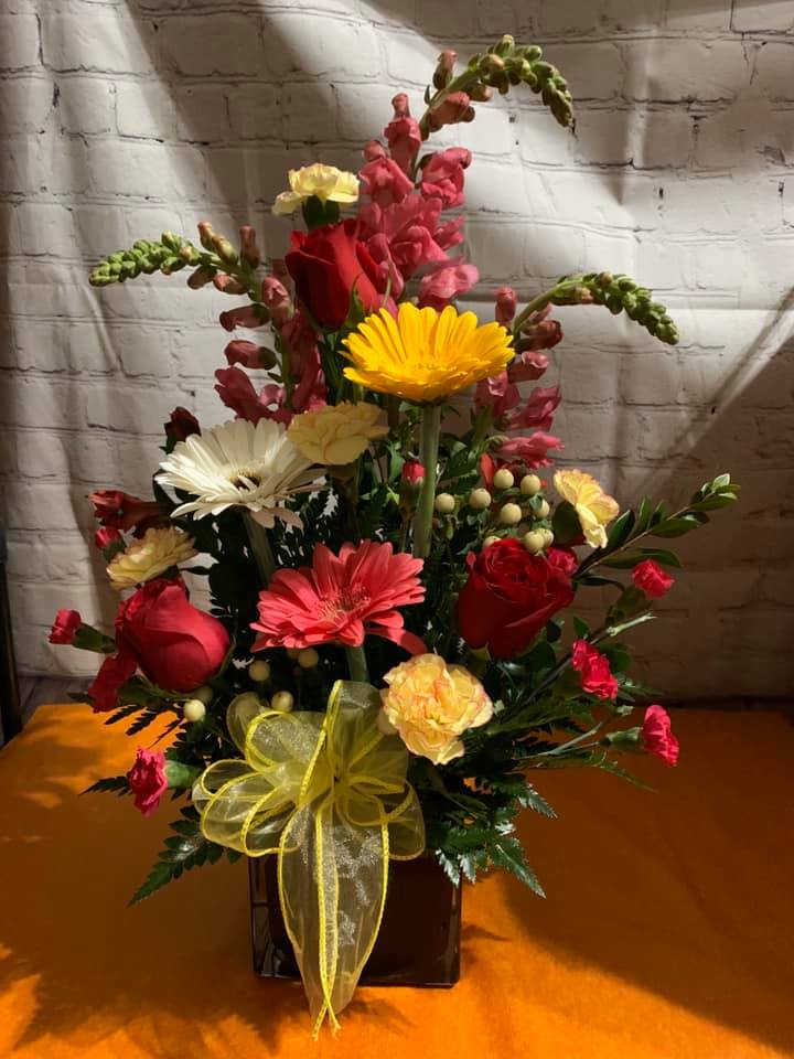 Pop Of Color Bouquet Pop Of Color Bouquet - An arrangement of Gerber Daisies mixed with a variety of flowers in a cube.