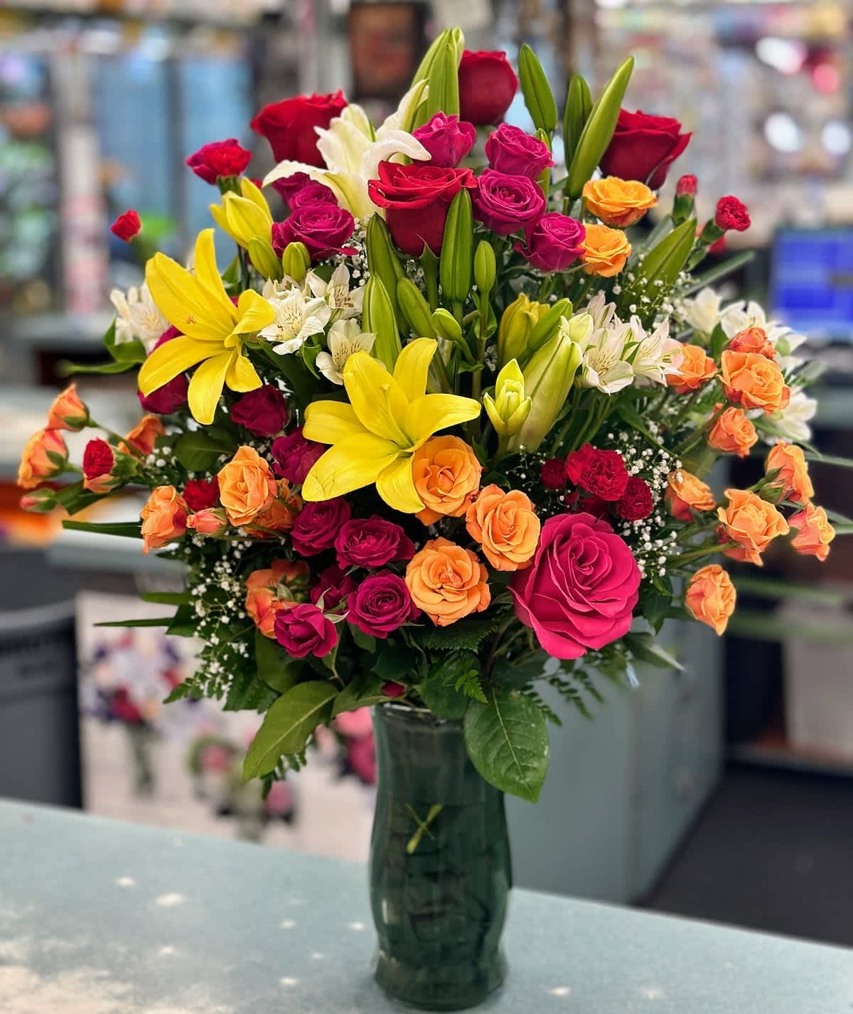 Roses,lilies,sprayroses,alstroemerias,lemon leafs  - Vibrant colors to show you love. 