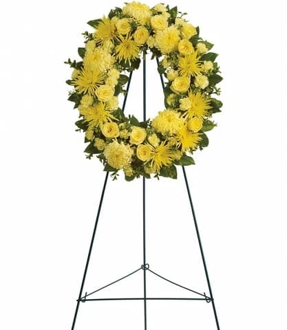 ETERNAL SUNSHINE - This lovely medley of yellow flowers so beautifully arranged in a standing wreath is a reminder of the joy of life even during the darkest of times. It is an expression of hope that the family will deeply appreciate and long remember.  Approximately 22 1/2 W x 25 1/2 H.  