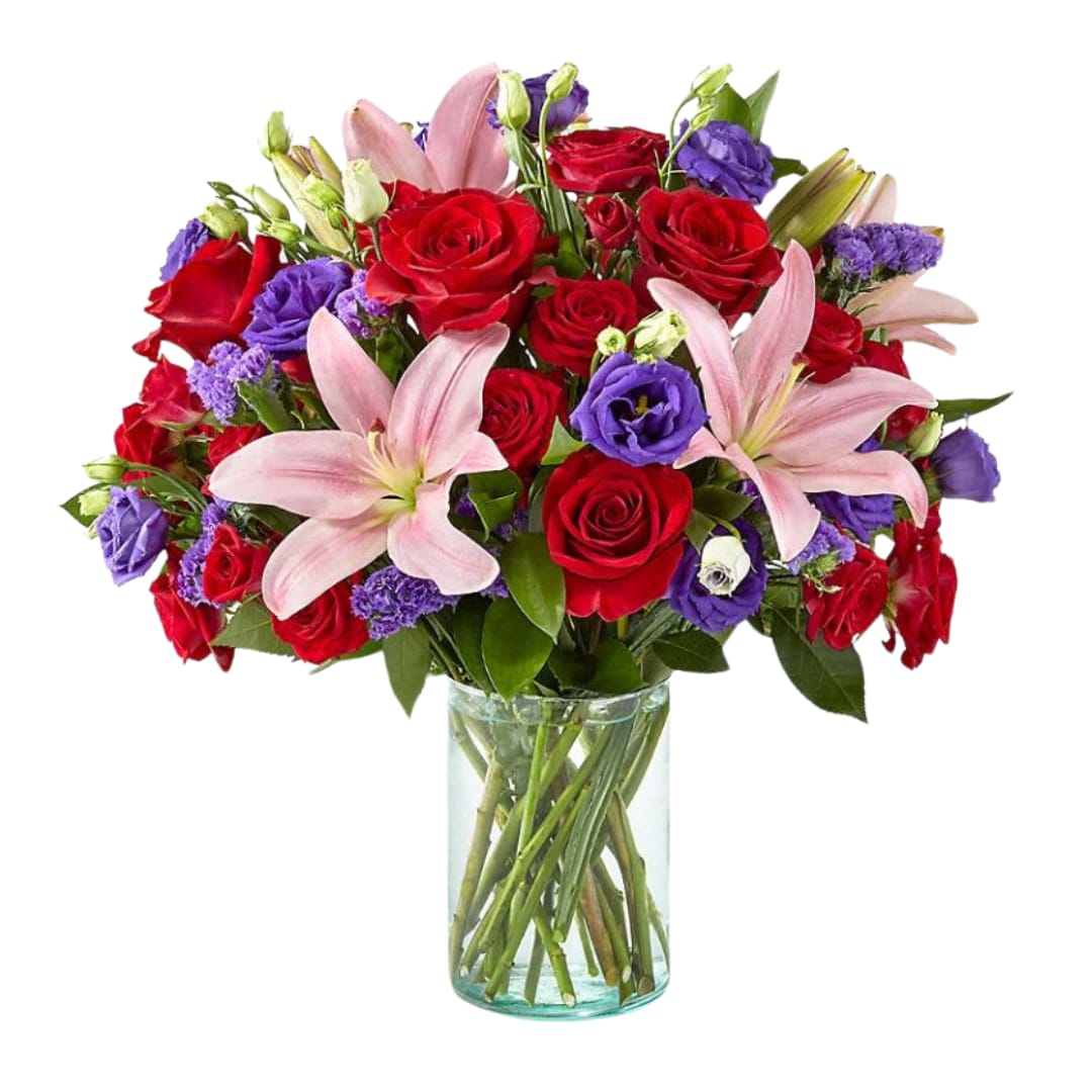 The FTD® Truly Stunning™ Bouquet - Share a smile with your loved ones through a bouquet filled with stunning beauty and heartfelt joy. Comprised of vivid red roses, purple double lisianthus, pink lilies and red spray roses within a clear glass vase, vibrant color bursts from every bloom. Make their day brighter with a gift that is Truly Stunning™!  