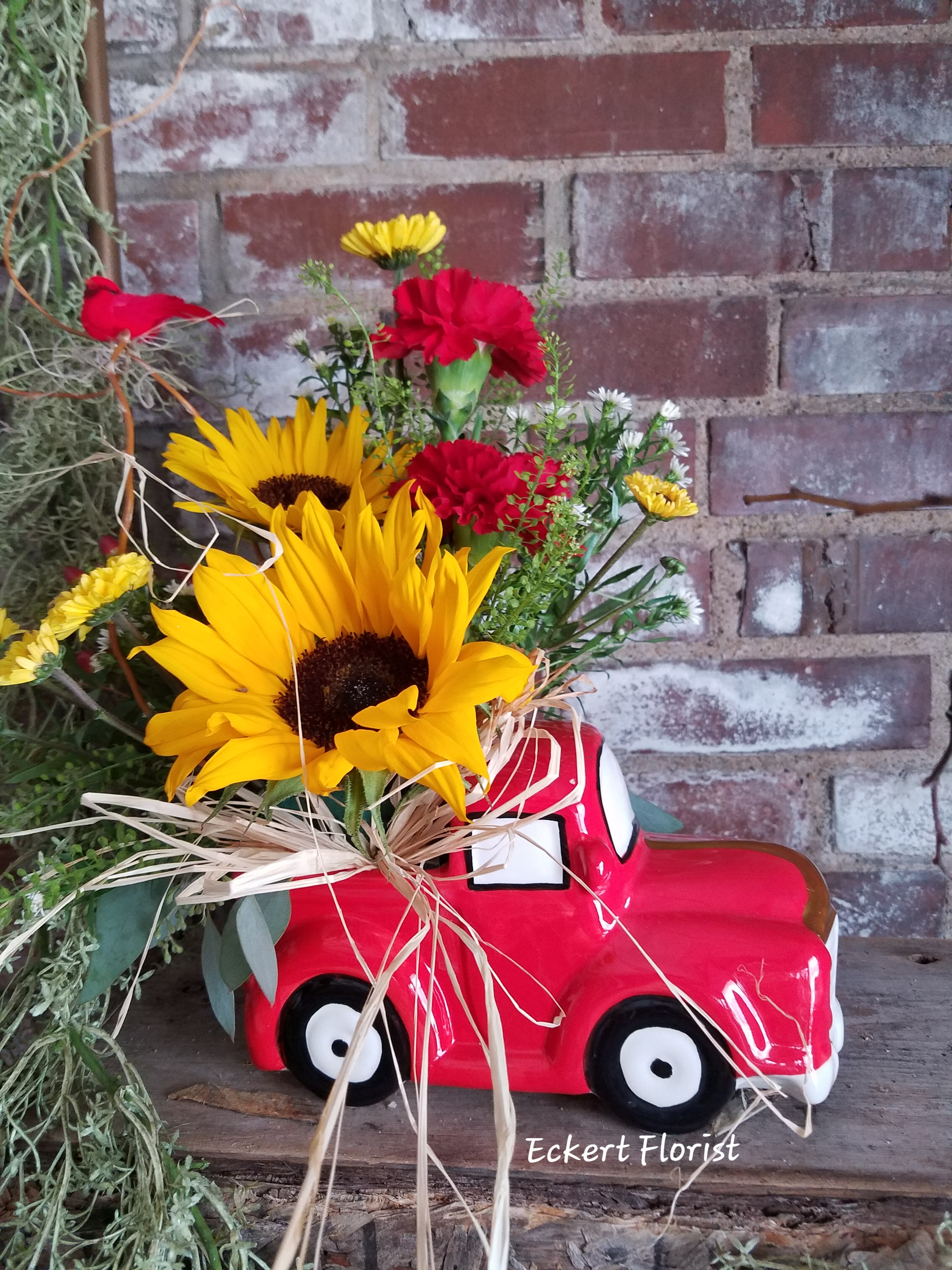 Eckert Florist's Red Truck Of Blooms *LOCAL DELIVERY ONLY - This red ceramic truck is filled with fresh-cut blooms of the season. Standard Truck measures approx. 8&quot; long x 4&quot; wide x 4&quot; high *LOCAL DELIVERY ONLY