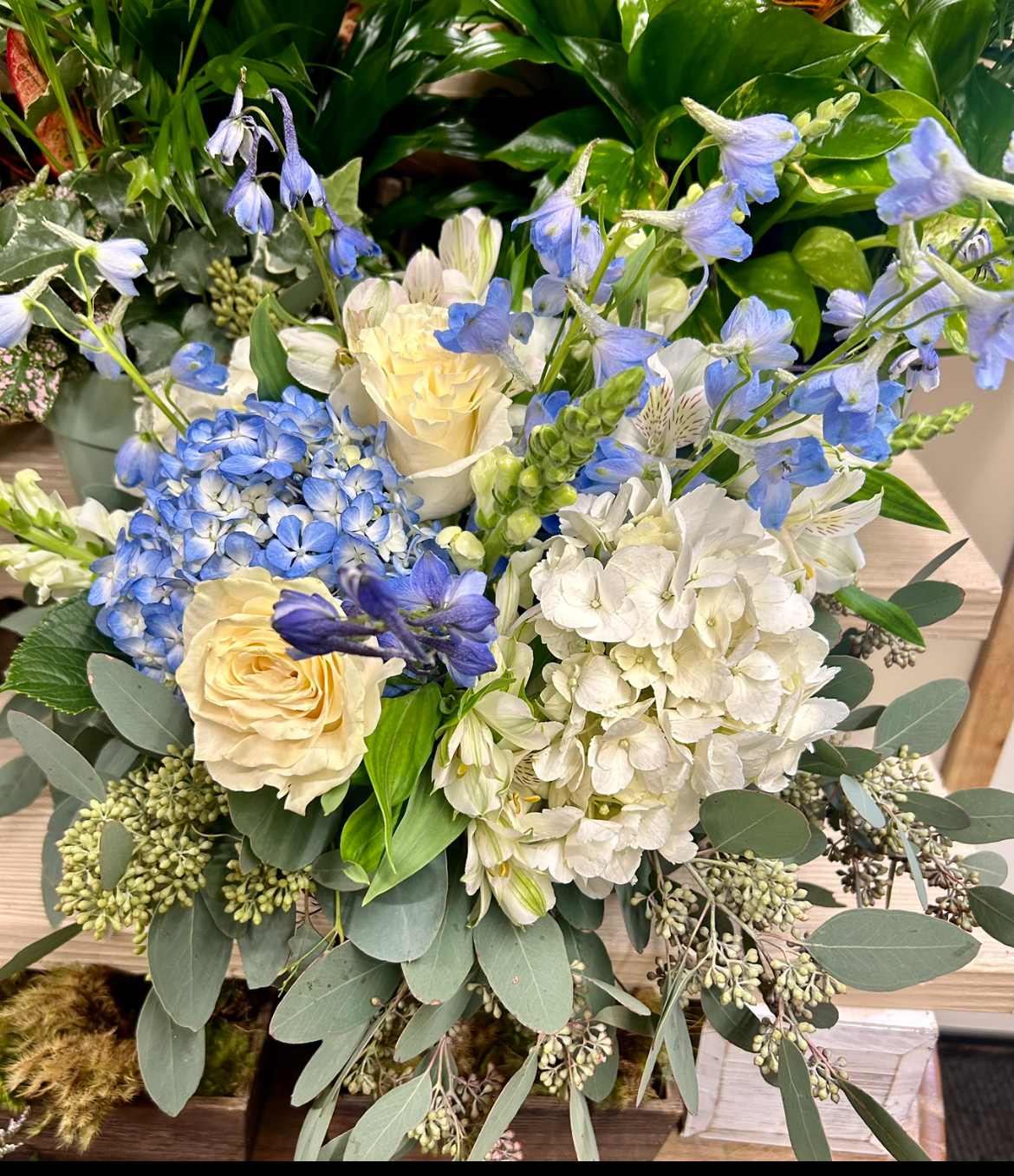 Blue sky vase arrangement - Hydrangeas, Delphinium, roses, and eucalyptus all blues and whites