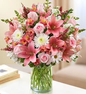 Sincerest Sorrow - Pink and White - Product ID: 95392   Elegance and grace in abundance mark our pink and white sympathy arrangement. The freshest roses, snapdragons, lilies, alstroemeria, stock and more are gathered by hand in a classic cylinder vase to offer a lovely tribute and display of your caring sympathies. Lush bouquet of the freshest pink roses, snapdragons, lilies, alstroemeria and heather, paired with white cremones and stock and accented with variegated pittosporum, salal and myrtle Hand-designed by our expert florists in a classic glass cylinder vase; vase measures 8&quot;H Can be sent to the home of friends, family members or business associates, or to the funeral service Large arrangement measures approximately 24&quot;H x 22&quot;L Medium arrangement measures approximately 22&quot;H x 20&quot;L Small arrangement measures approximately 20&quot;H x 18&quot;L Our florists hand-design each arrangement, so colors, varieties, and container may vary due to local availability Lilies may arrive in bud form and will open to full beauty over the next 2-3 days