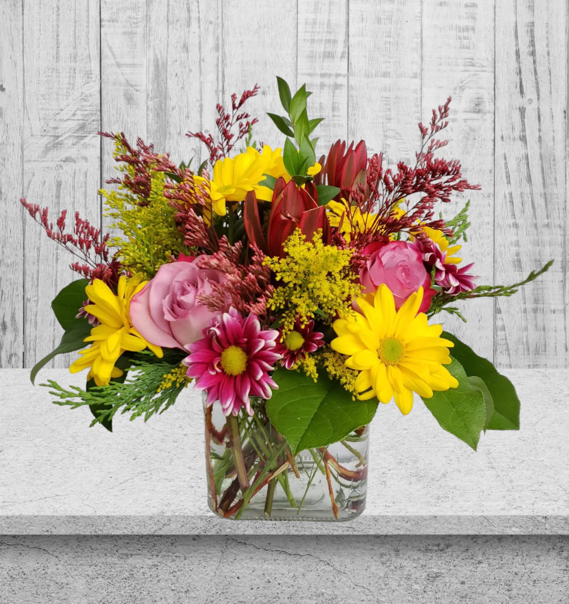 Just Because Just Because - Welcome to Specialty Floral Design, where we bring creativity and elegance to every bloom. Introducing our charming creation, the "Just Because" bouquet, a delightful fusion of nature's finest hues crafted to brighten any space and occasion. Nestled in a sleek square vase, this arrangement exudes simplicity and sophistication. Vibrant yellow daisies dance alongside the golden rays of solidago, while the gentle fragrance of lavender roses fills the air with tranquility. Adding a touch of allure, the leucadendron lends a unique texture, elevating the bouquet. Perfectly sized for a desk at the office or an end table in your bedroom, the "Just Because" bouquet effortlessly adds a pop of color and charm wherever it goes. Whether it's to celebrate a birthday, convey heartfelt sentiments on Mother's Day, or simply to let someone know you're thinking of them, this versatile arrangement is an ideal choice. Let our flowers speak volumes when words fall short. Surprise your loved ones with the "Just Because" bouquet and watch as smiles bloom with every petal. Order now and let us deliver joy straight to your doorstep. Specialty Floral Design offers same-day delivery to Olympia, WA, Tumwater, WA, and Lacey, WA. We also deliver to surrounding areas. Once you Google "florist near me," we hope you find us and choose to order flowers for your friends and family from our website.